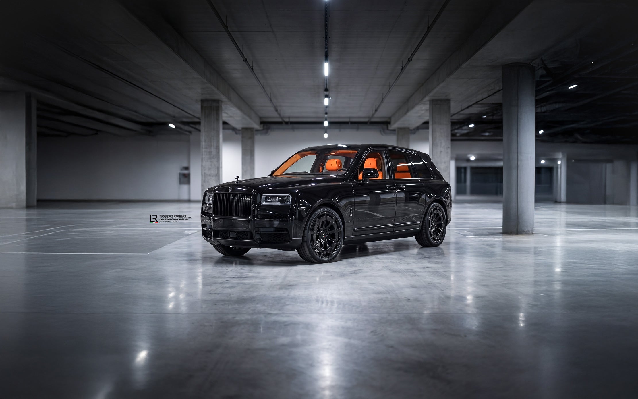 Custom Rolls Royce Cullinan Black Badge on 24 Inch LOMA Refined Forged Wheels with orange interior and downpipe exhaust front side view wide angle.