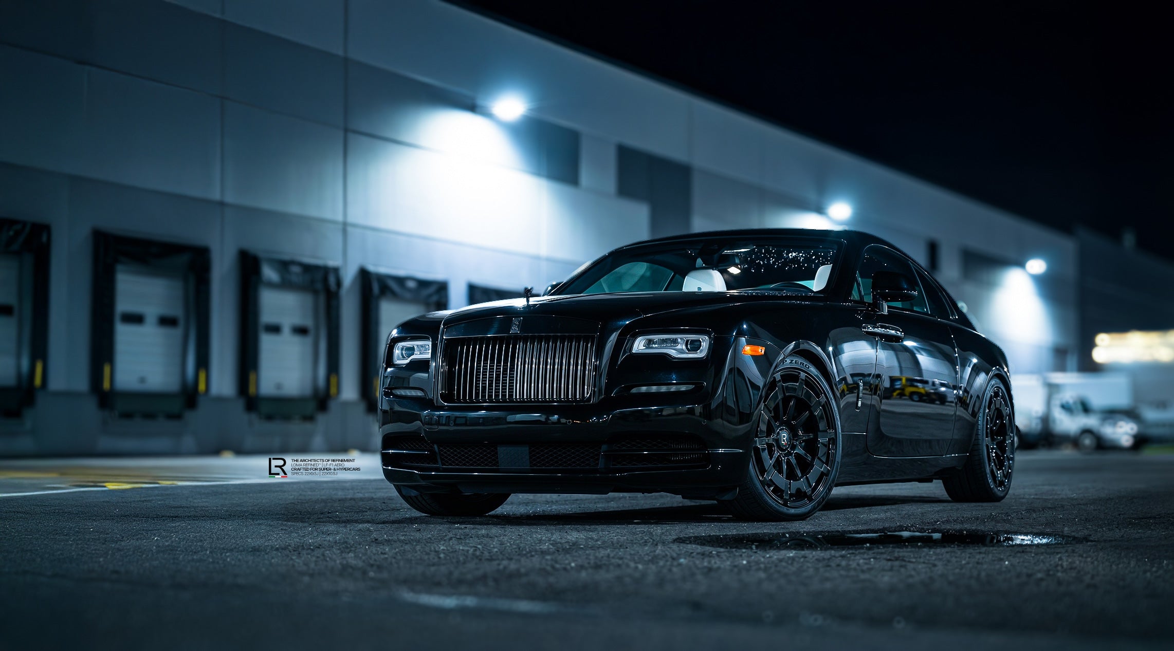 Custom Rolls Royce Wraith Black Badge on LOMA Refined LF-F1 Aero 22-Inch wheels wide angle front side view.